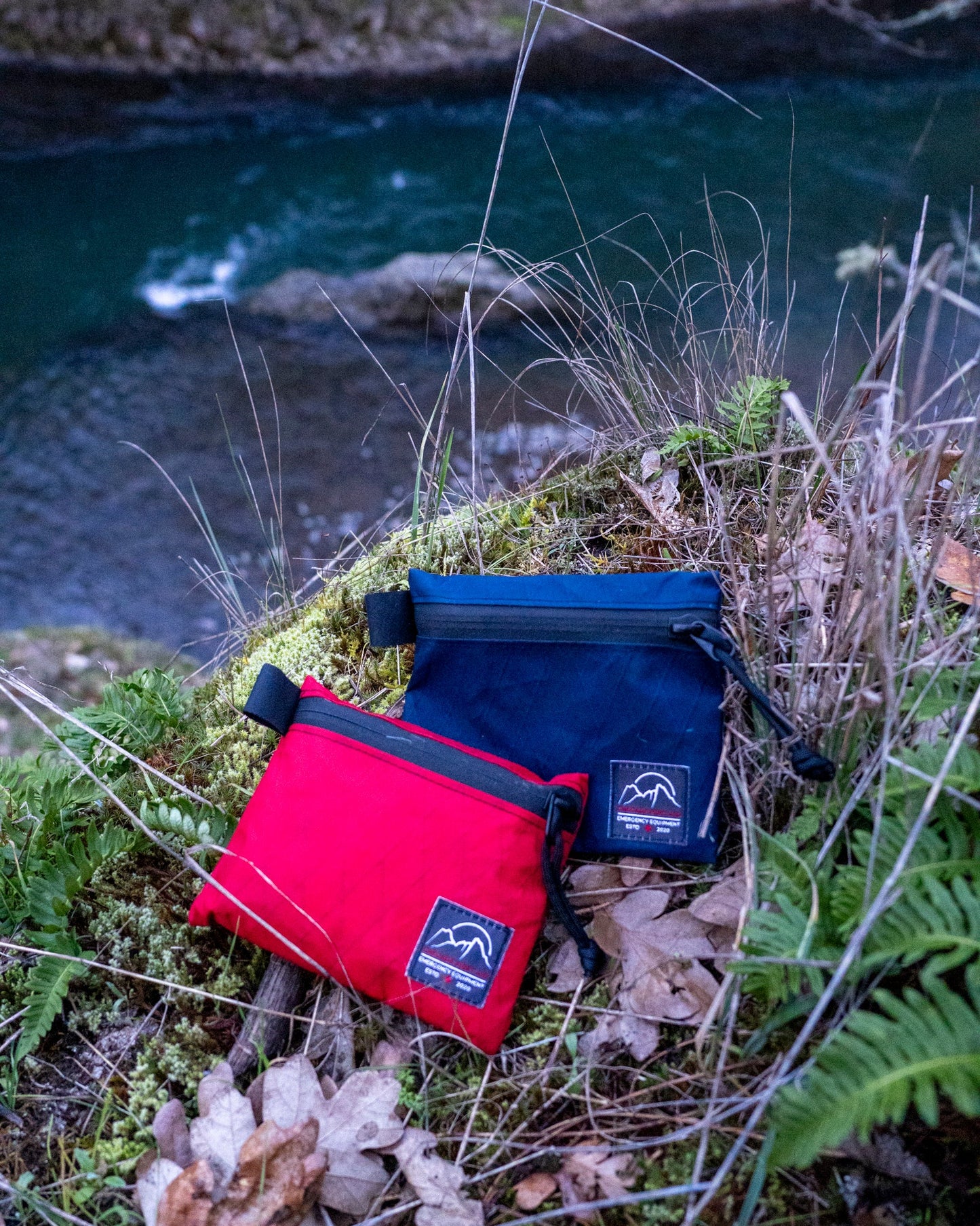 Everyday Explorer kits in red and navy, water-resistant first aid kits perfect for hiking and scenic river views | Cascade First Aid