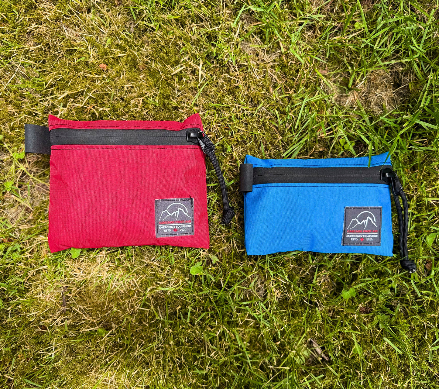 Medium red Bits bag next to Small blue Bits bag. Ultralight, highly weather-resistant Xpac construction. From Cascade First Aid
