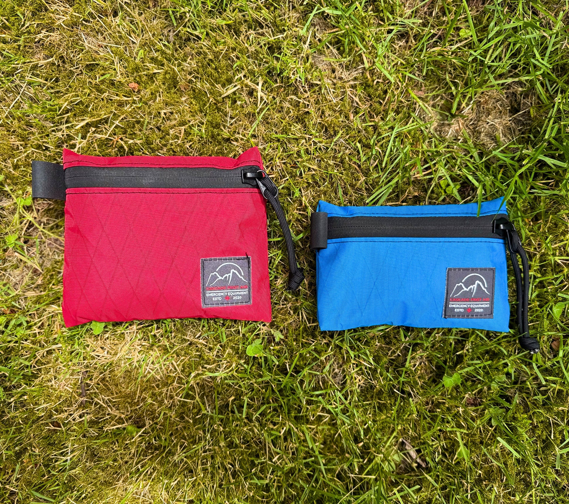 Medium red Bits bag next to Small blue Bits bag. Ultralight, highly weather-resistant Xpac construction. From Cascade First Aid